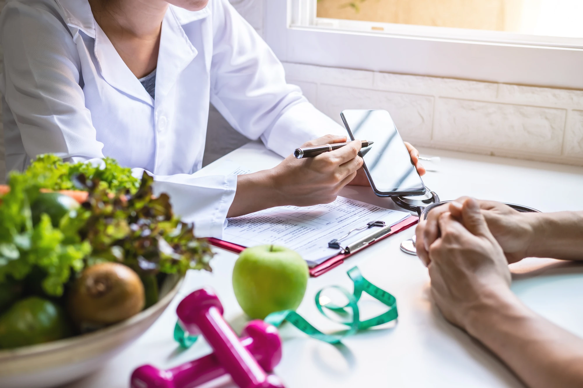 Nutrition consultation with fruits and exercise equipment.