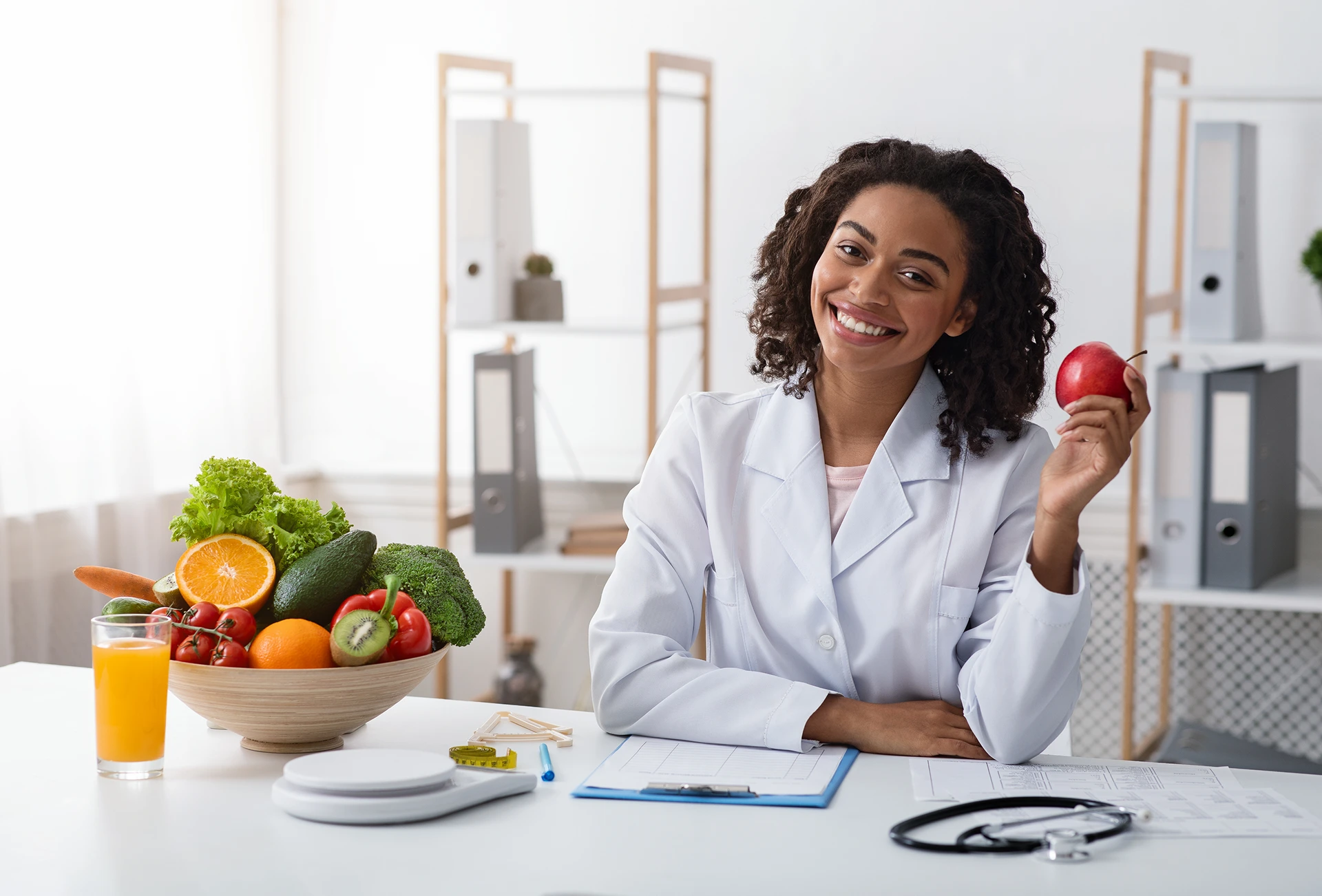 Smiling nutritionist with fruits and vegetables.