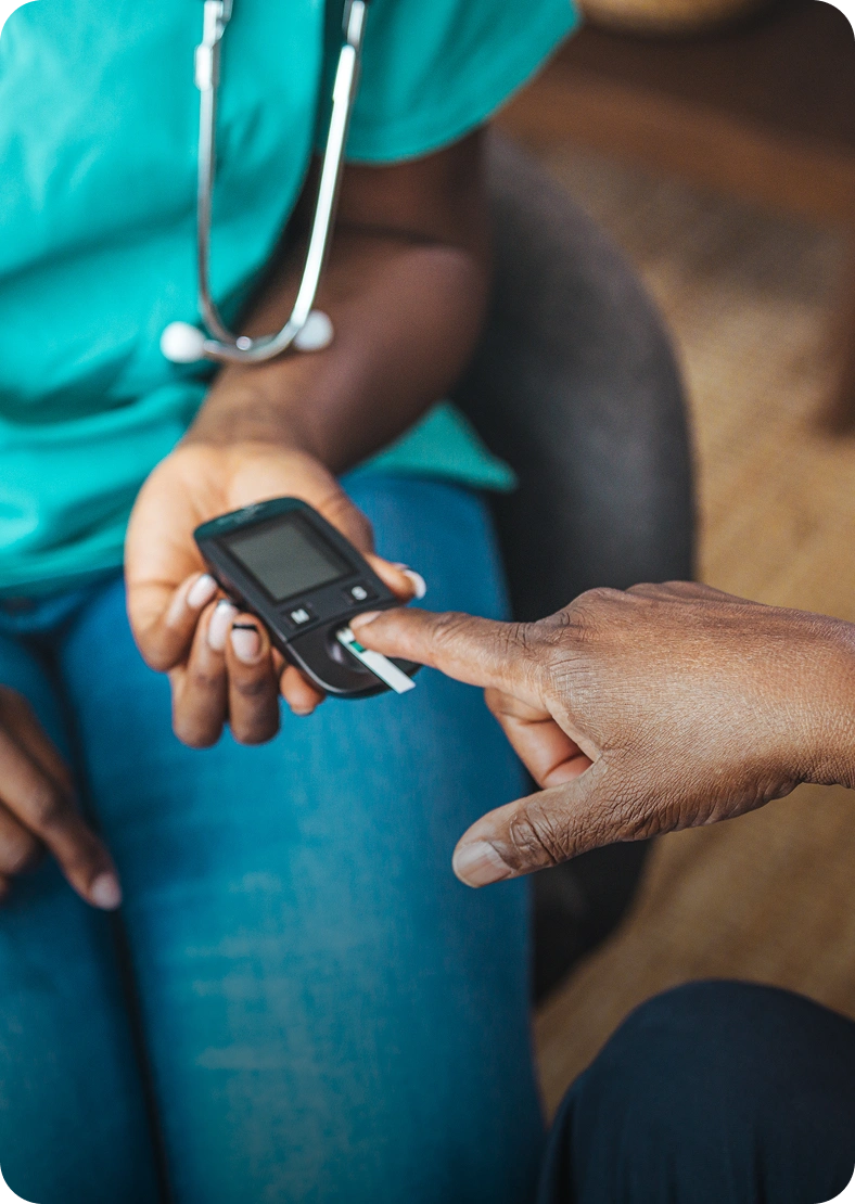 Person using glucometer for blood sugar test.